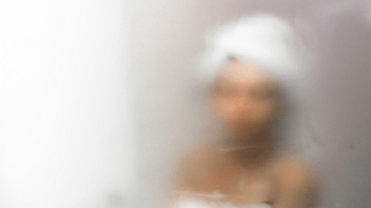 How A Steam Stopper Can Improve Your Wellbeing, Woman wrapped in towel out of focus obscured by blurry steam
